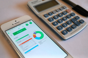 calculator and phone used for budgeting