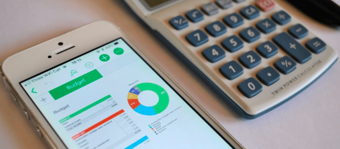 calculator and phone used for budgeting