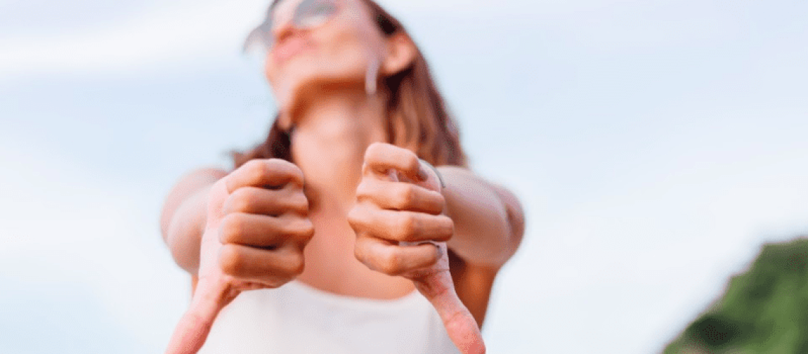 woman putting her thumbs down